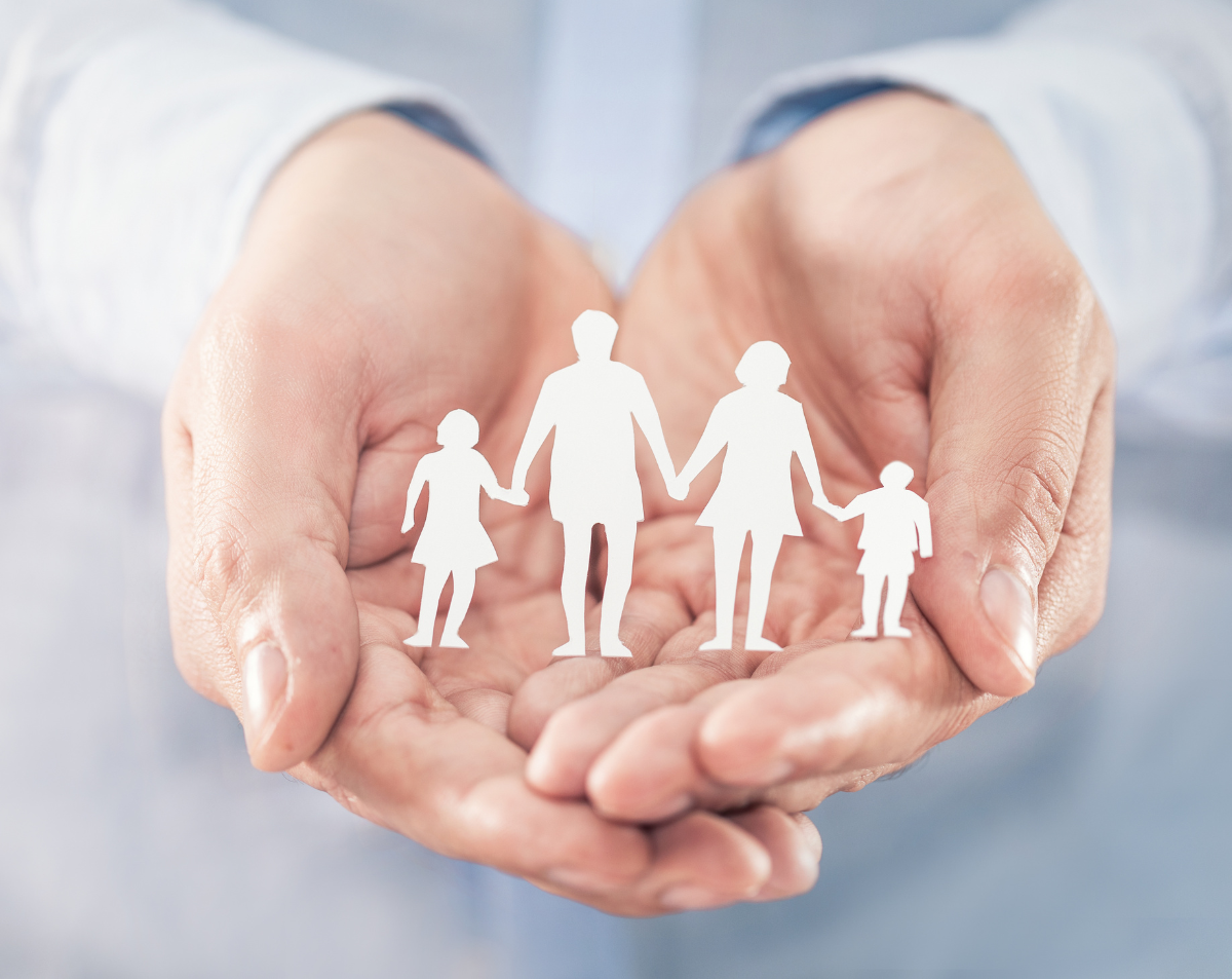 Hands holding paper cutouts of a family, symbolizing personalized care and continuity of relationships in healthcare.