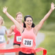 Successful 5K runner celebrating finish line and healthy heart