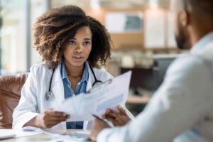 young physician examining a busy professional at professional's office