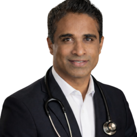 Dr. Srinivas Reddy, M.D., Adult Medicine Specialist, wearing a stethoscope, smiling confidently in a professional setting.