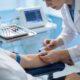 Medical professional administering injection and ultrasound diagnostic services.